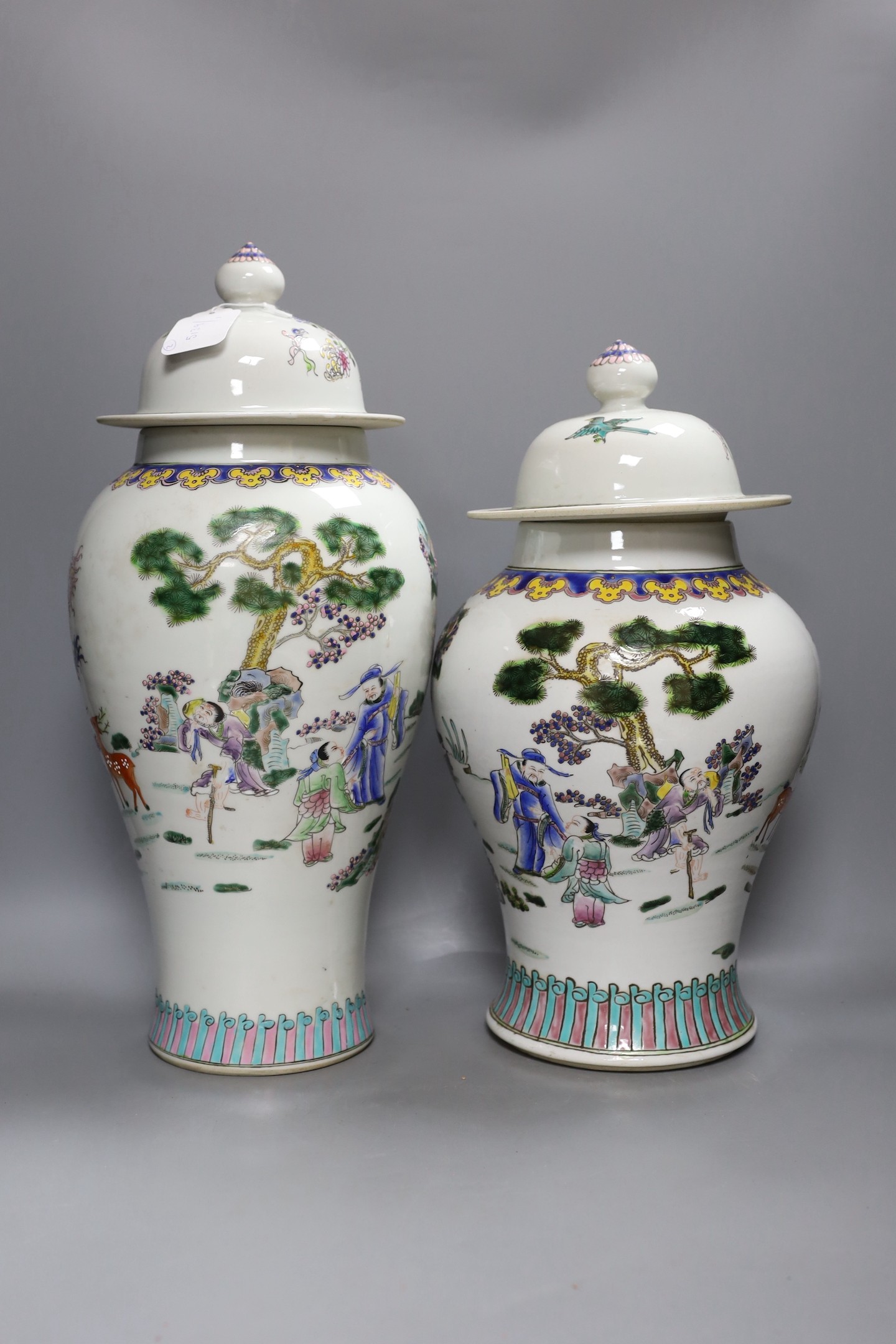 Two Chinese famille rose vases and covers, tallest 46cm high